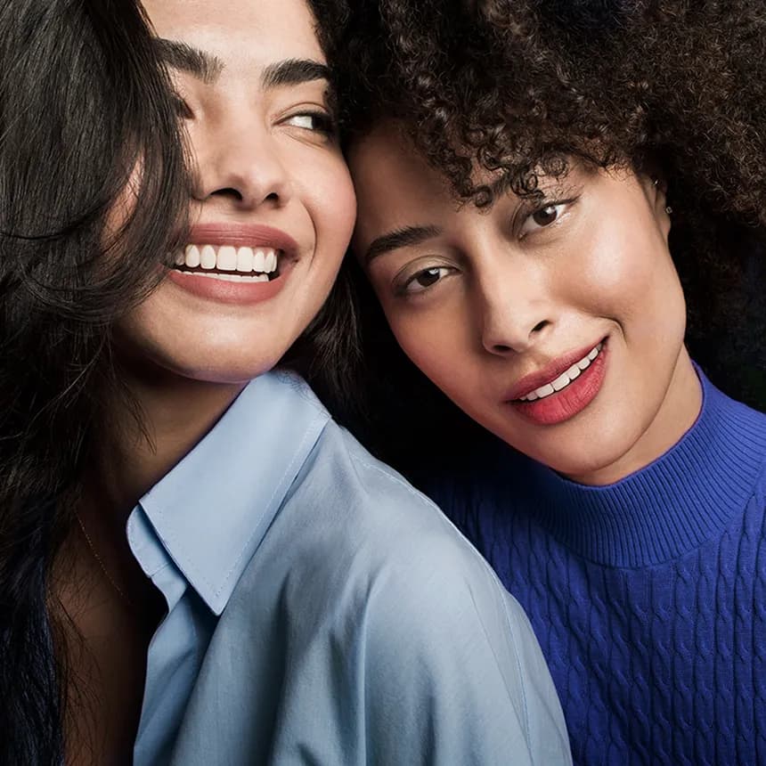 Two adult females smiling after orthodontic treatment