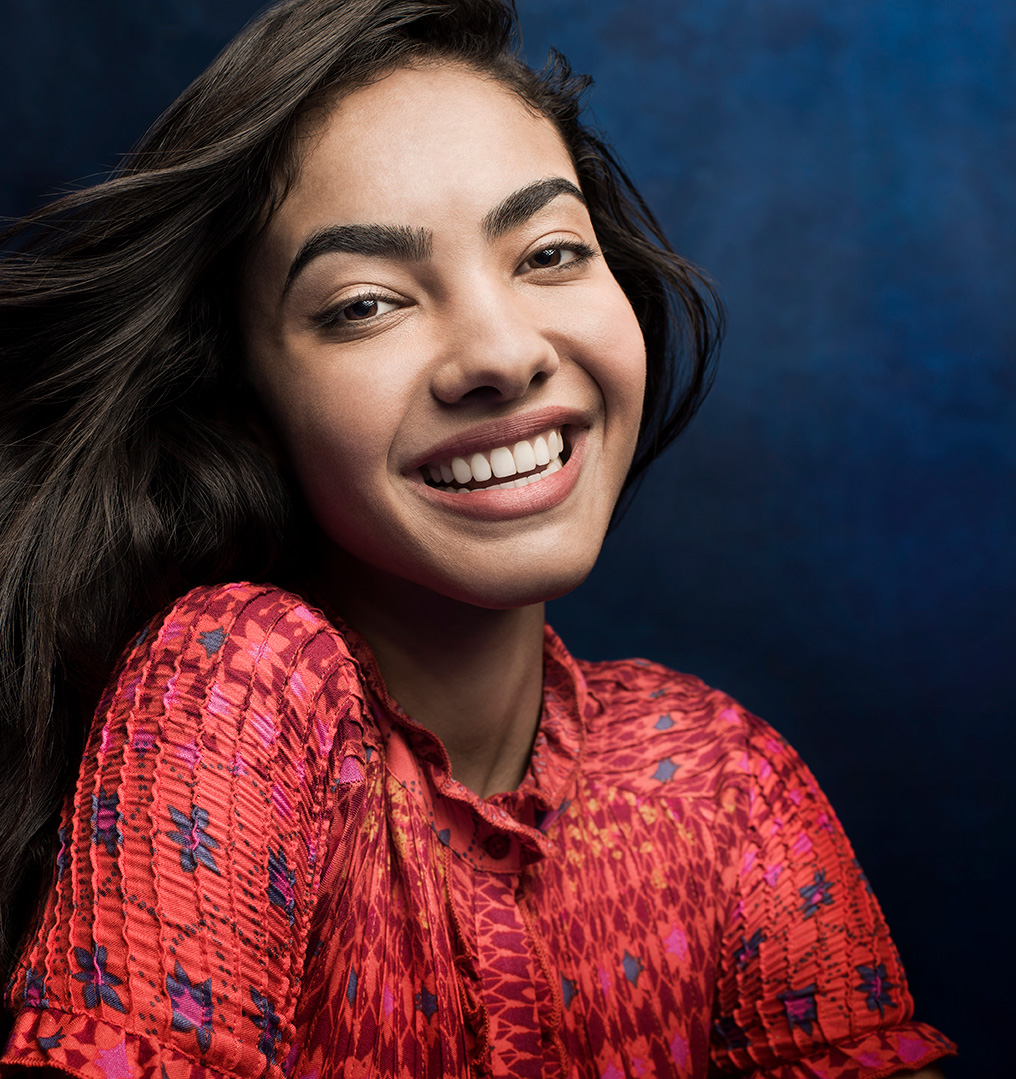 Young adult woman smiling after aligner treatment