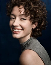 Smiling young adult female patient after treatment